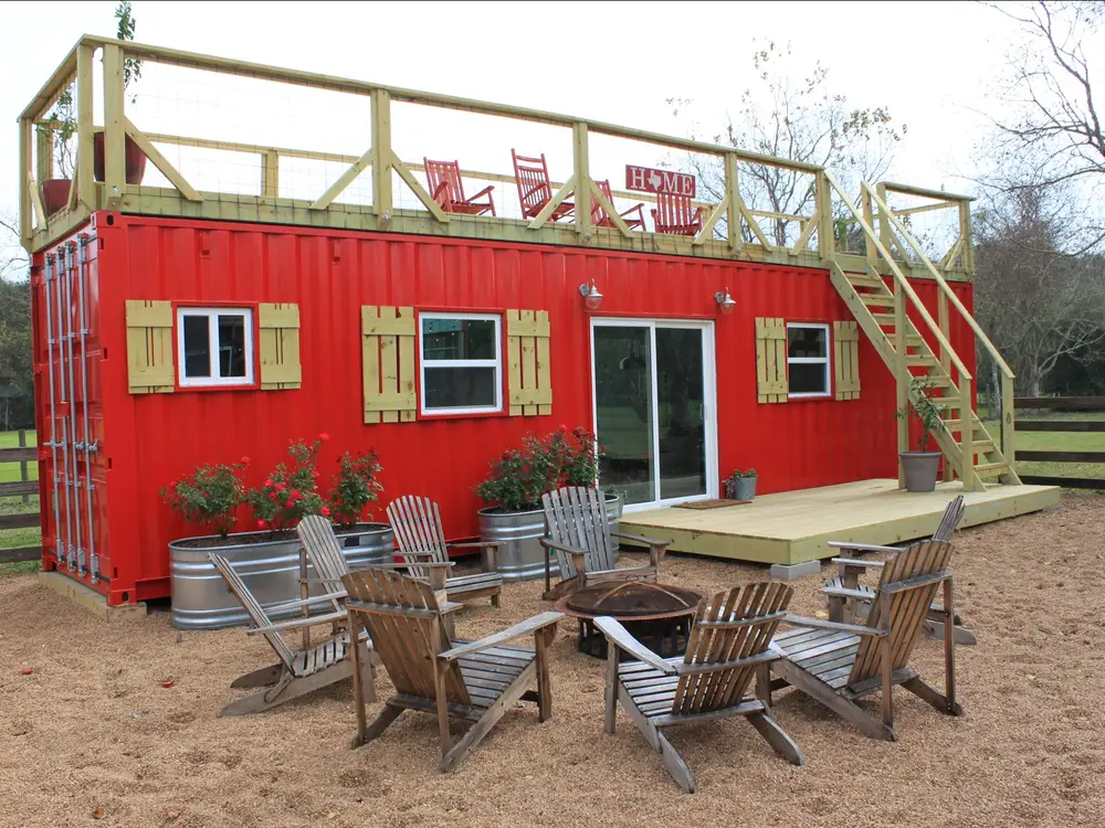converted shipping container into a mobile tiny rustic farmhouse with rooftop deck